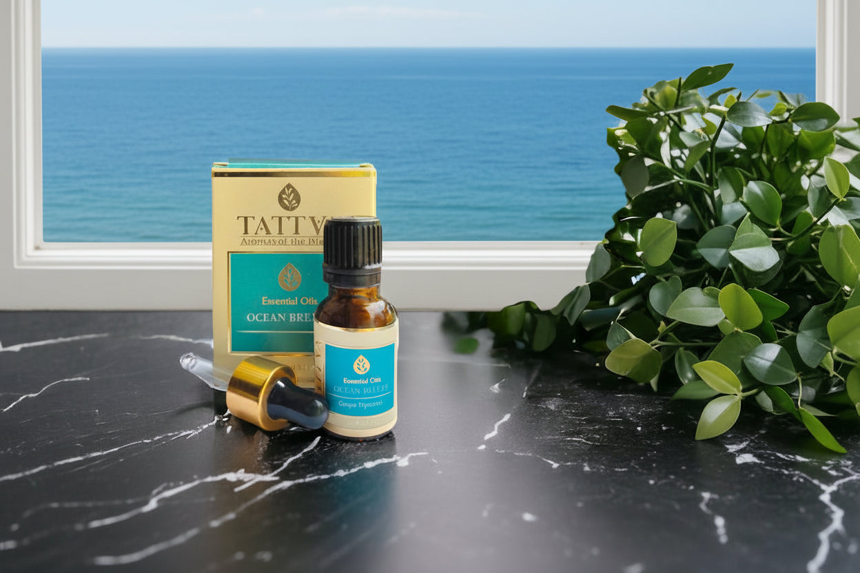 Ocean Breeze essential oil and packaging with greenery and the sea in the background