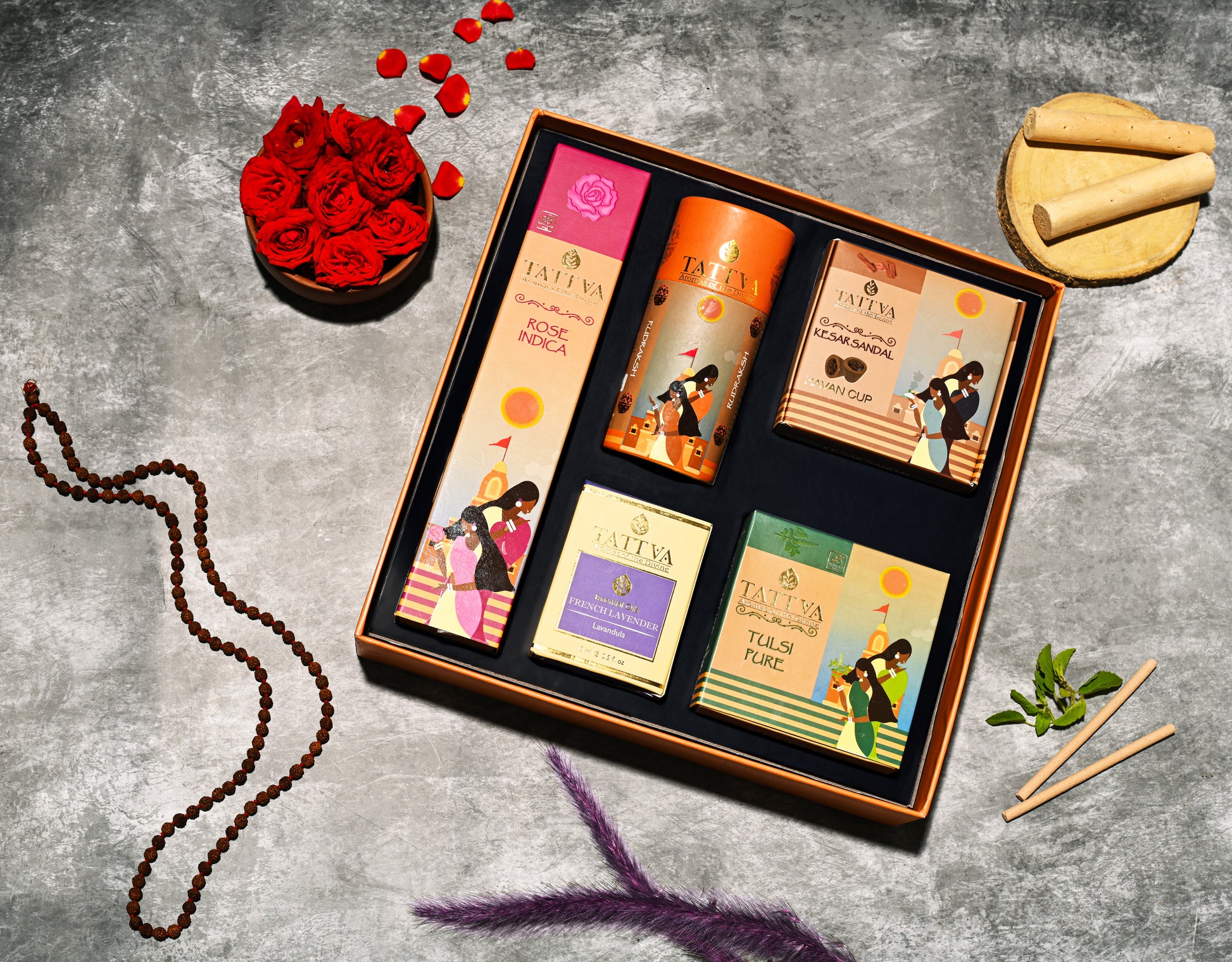 Fragrance set of incense with bottles and boxes on a grey surface with decorative elements, Fragrances are Sandalwood, Rose, kesar sandal and Tulsi/Basil & Ocean Breeze