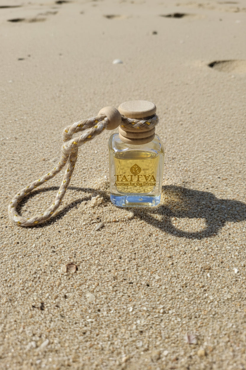 car freshener bottle on a sandy beach